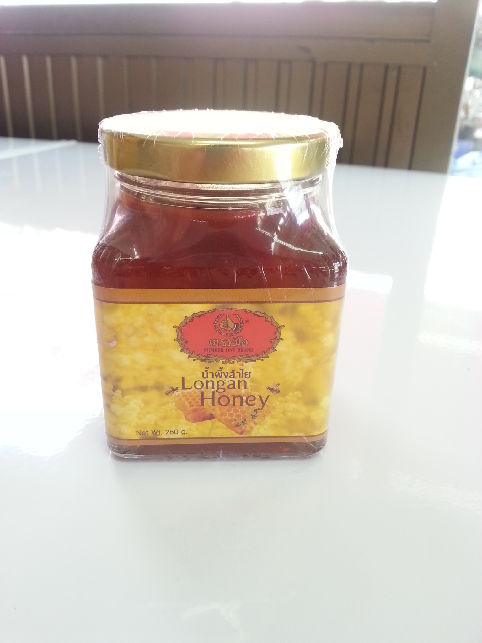 นํ้าผึ้งลำไย ตรามือ 200g.